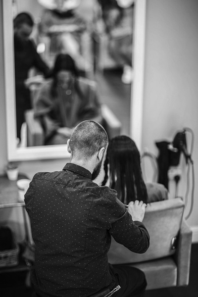 Stylist supporting a client during a salon service
